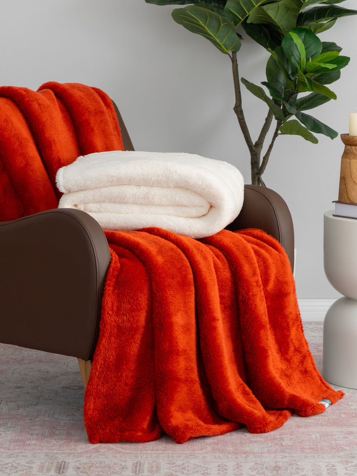 Extra-Fluffy collection image featuring our Extra-Fluffy 2pk in Hot Sauce draped over a brown leather chair.