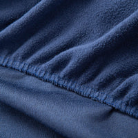A close-up of a fitted navy sheet, highlighting the fabric texture.