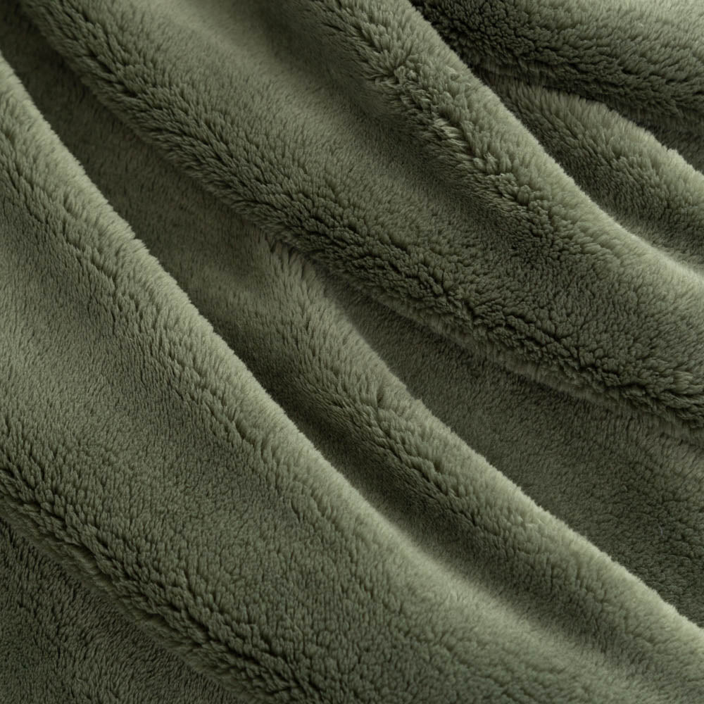 Close up of a green extra fluffy throw.