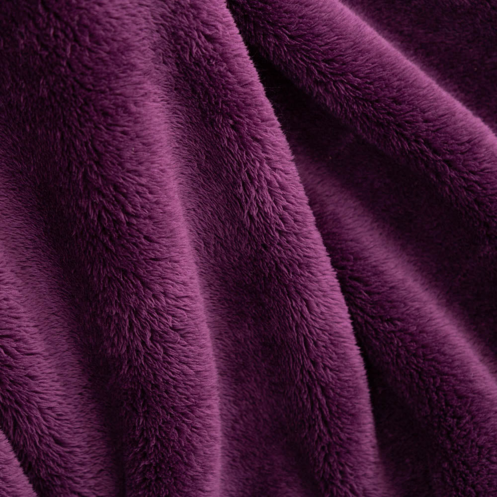 Close up of a purple extra fluffy throw.