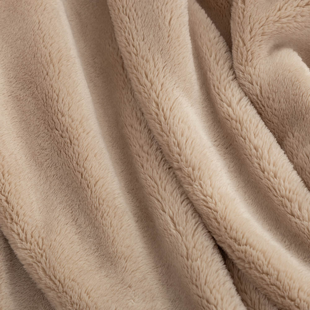 Close up of a tan extra-fluffy throw.