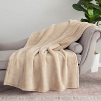 A tan extra-fluffy draped neatly over a grey chair.