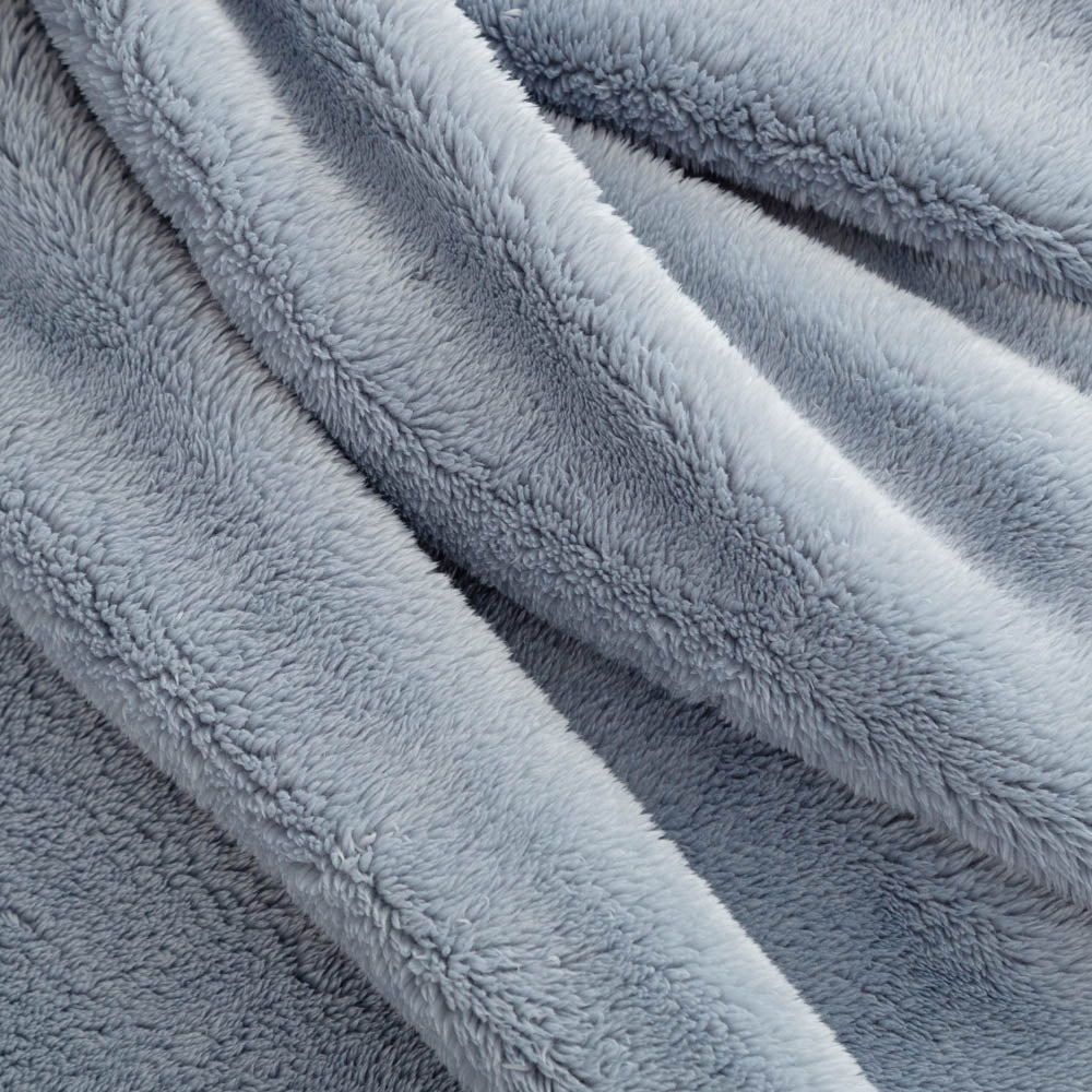 A close up of a blue extra-fluffy throw.