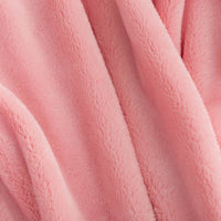 Close up of a pink extra fluffy throw.