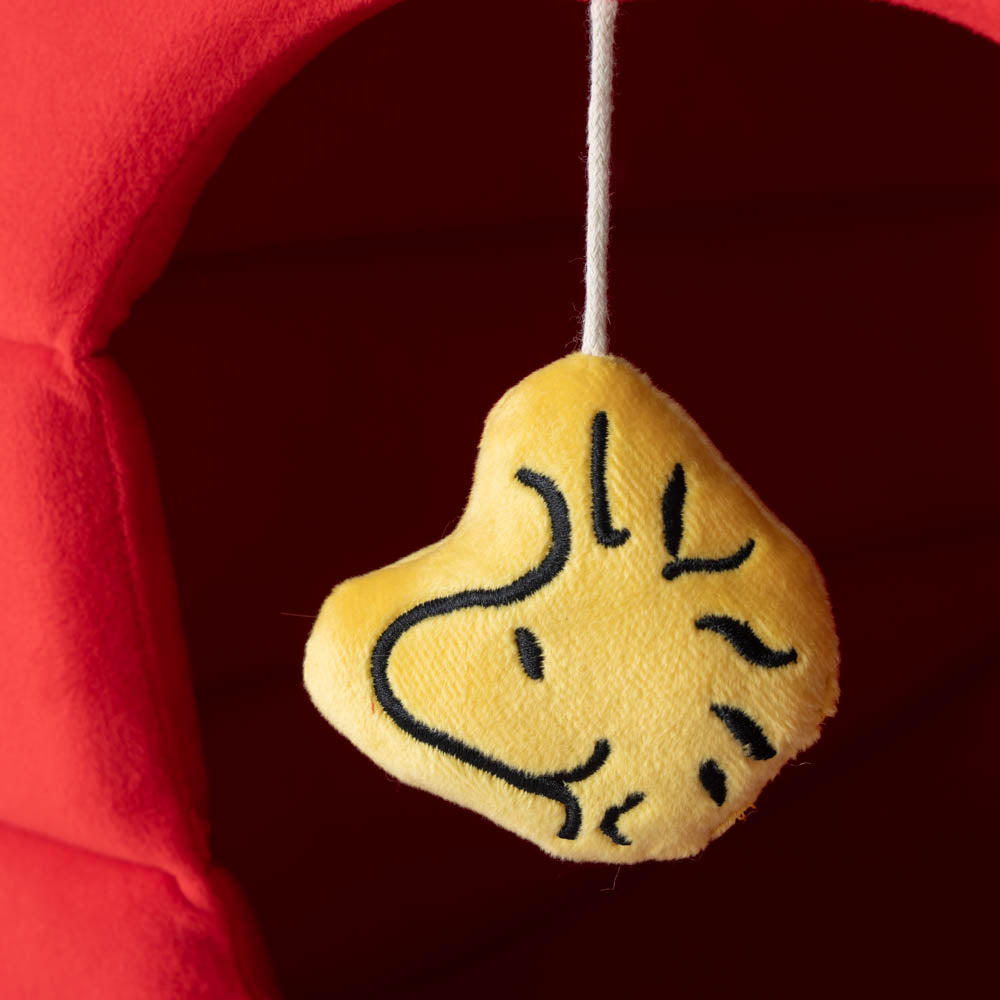 Close up of the woodstock dangle toy in our red Peanuts Snoopy Dog house pet bed.