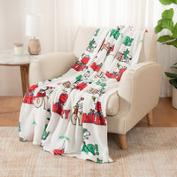 Decorative blanket with festive design draped over a chair in a living room.