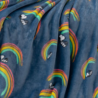 A close up of a blue rainbow snoopy throw displaying its plush texture.