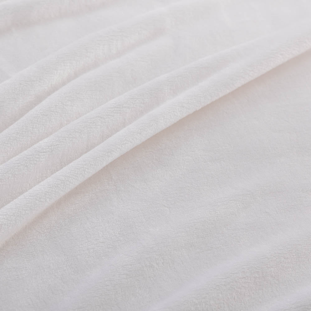 A close-up of a white velvet blanket showing its soft, smooth texture.