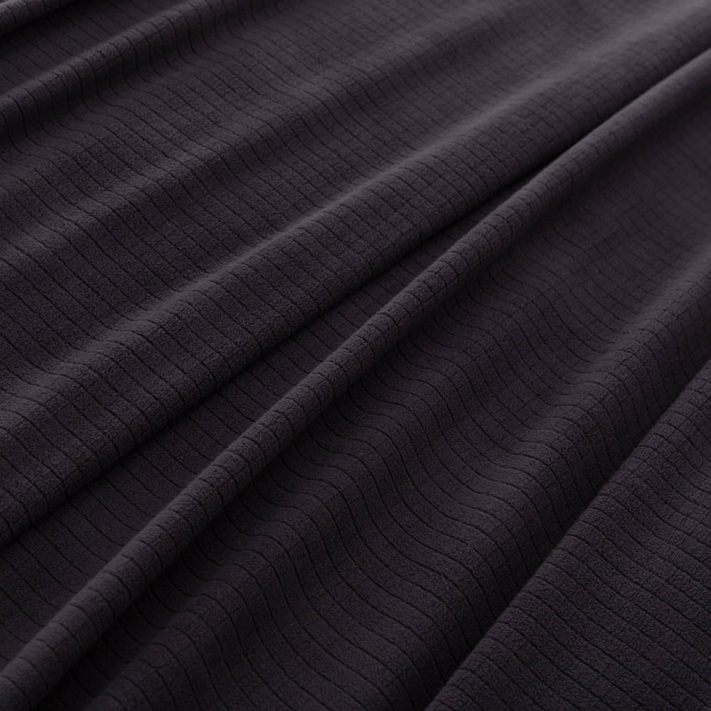 Close-up of the black fabric’s soft and textured microfleece material.
