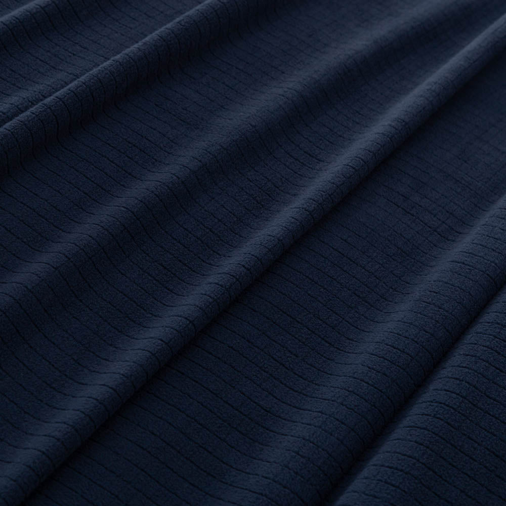 Close-up of the soft microfleece texture of the Polartec blanket in navy.