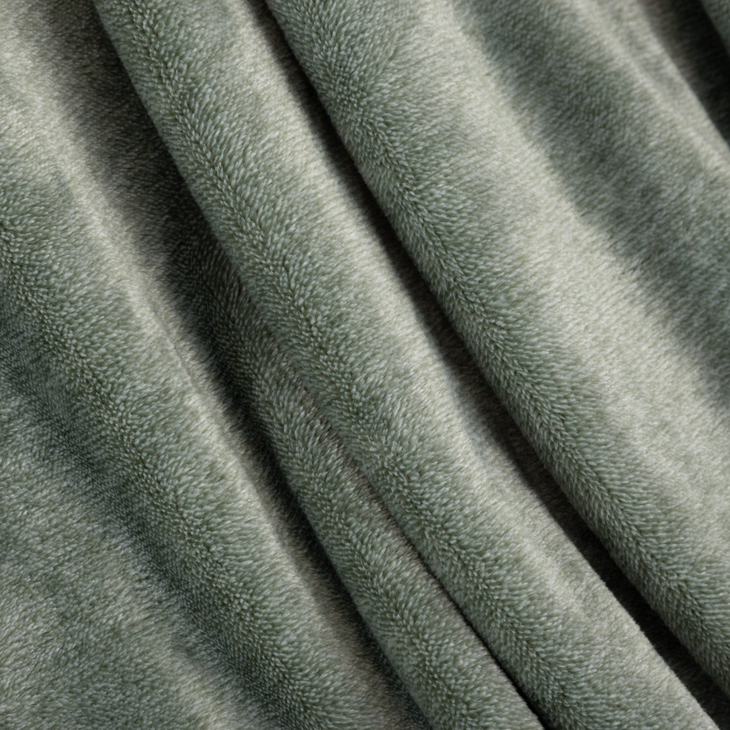 Close-up of textured green fabric with folds