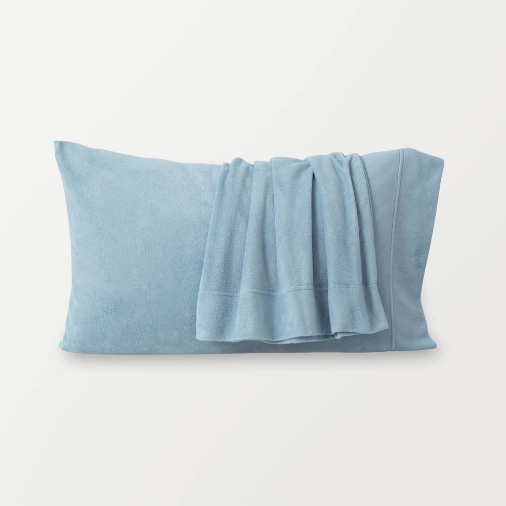Blue pillowcases displayed on a white surface.