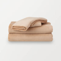 Folded Aruba Sand (beige color) sheet set on a clean, white background.