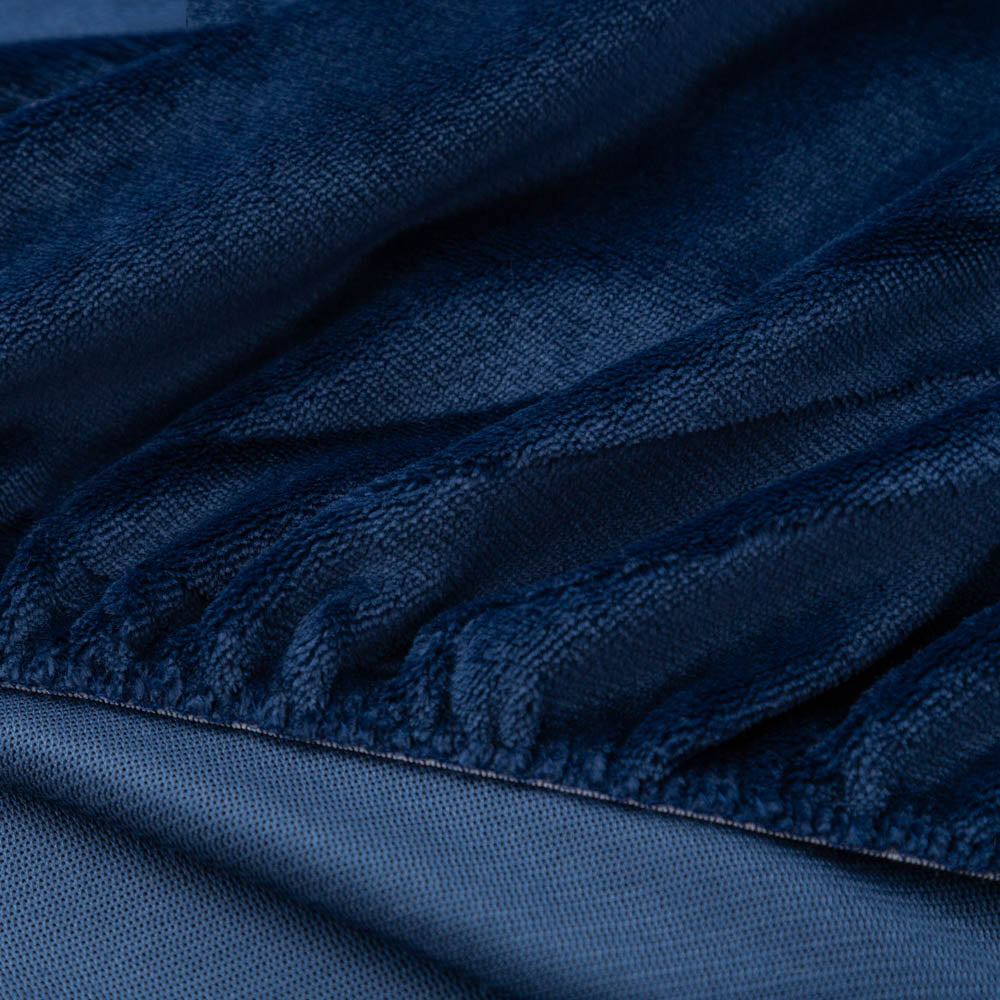 Close-up of Dress blue (navy) fitted sheet corner with plush texture.