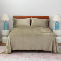 Dry Sage color plush sheet set on a large bed with two lamps on either side.