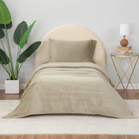 Dry Sage sheet set styled with neutral decor accent, plant on one side and nightstand on other side.