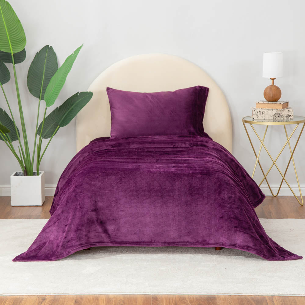 Eggplant sheet set styled on a bed.