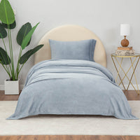 Polar Blue  (Light Blue) sheet set styled with neutral decor accent, plant on one side and nightstand on other side.
