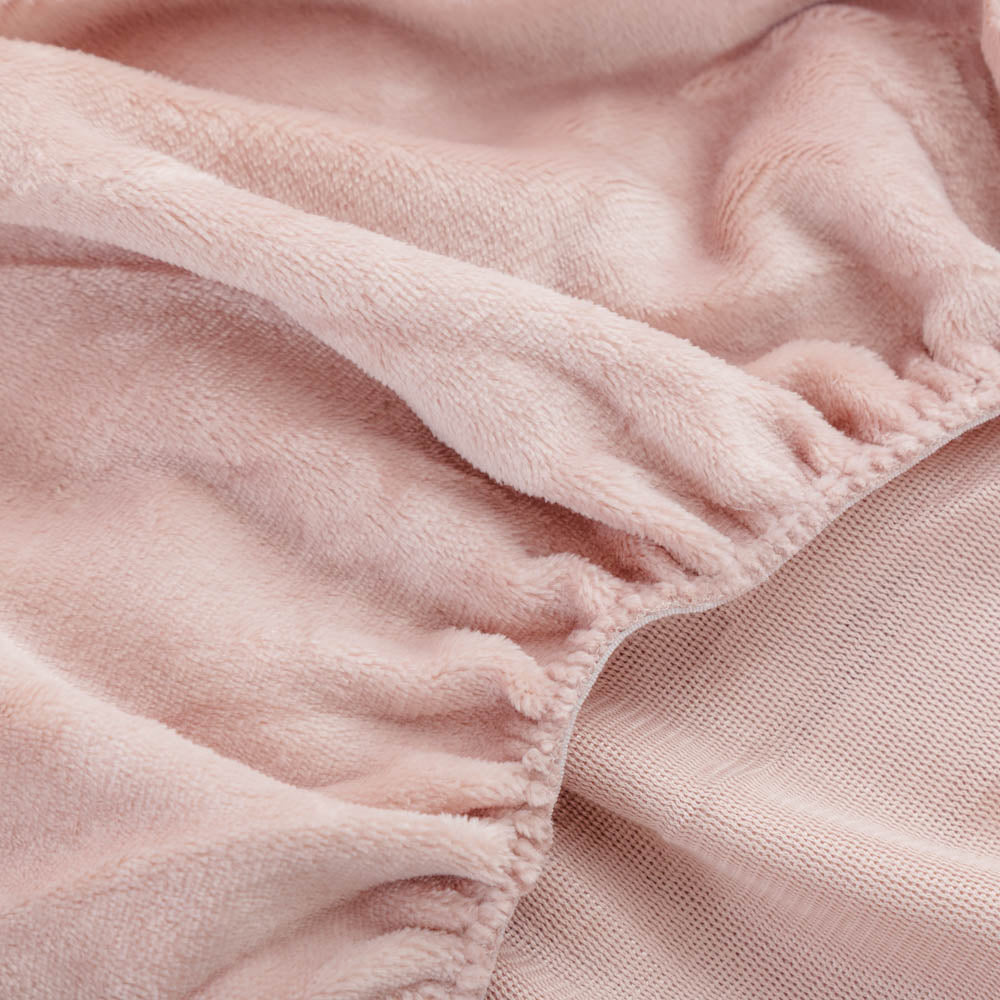 Close-up of a rose smoke fitted sheet corner.