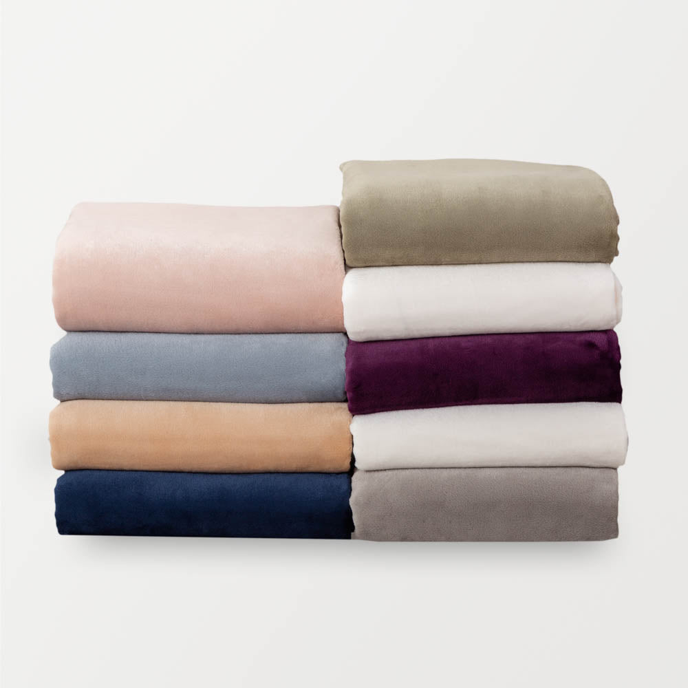 Folded stack of shrrt sets in variety of colors: rose smoke, polar blue, aruba sand, dress blue, dry sage, cream, eggplant, white, wild dove.