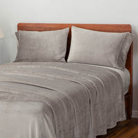 Wild Dove (gray) bedding set displayed on a large bed.