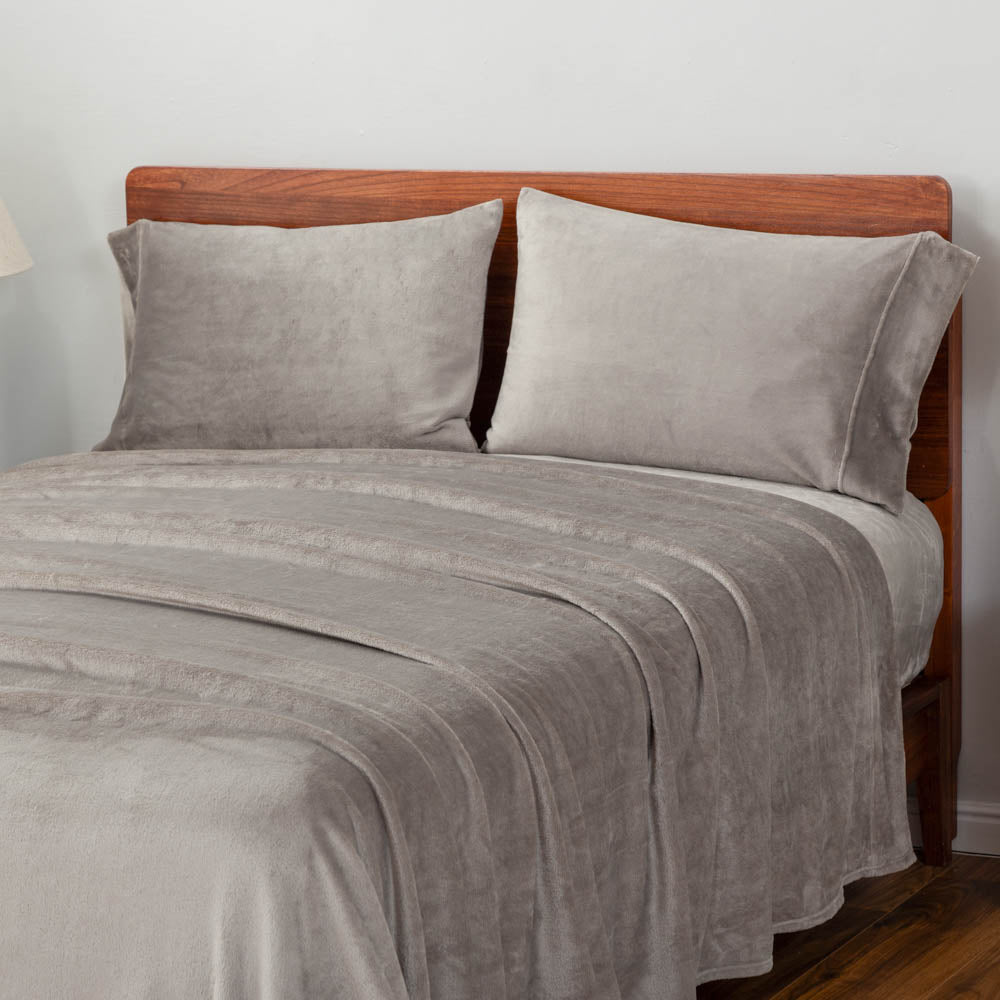 Wild Dove (gray) bedding set displayed on a large bed.