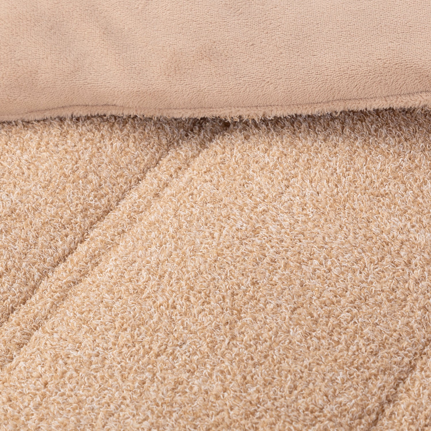 Close up shot to show the two reversible fabrications of the Retro Plush comforter set in Sumatra blend.