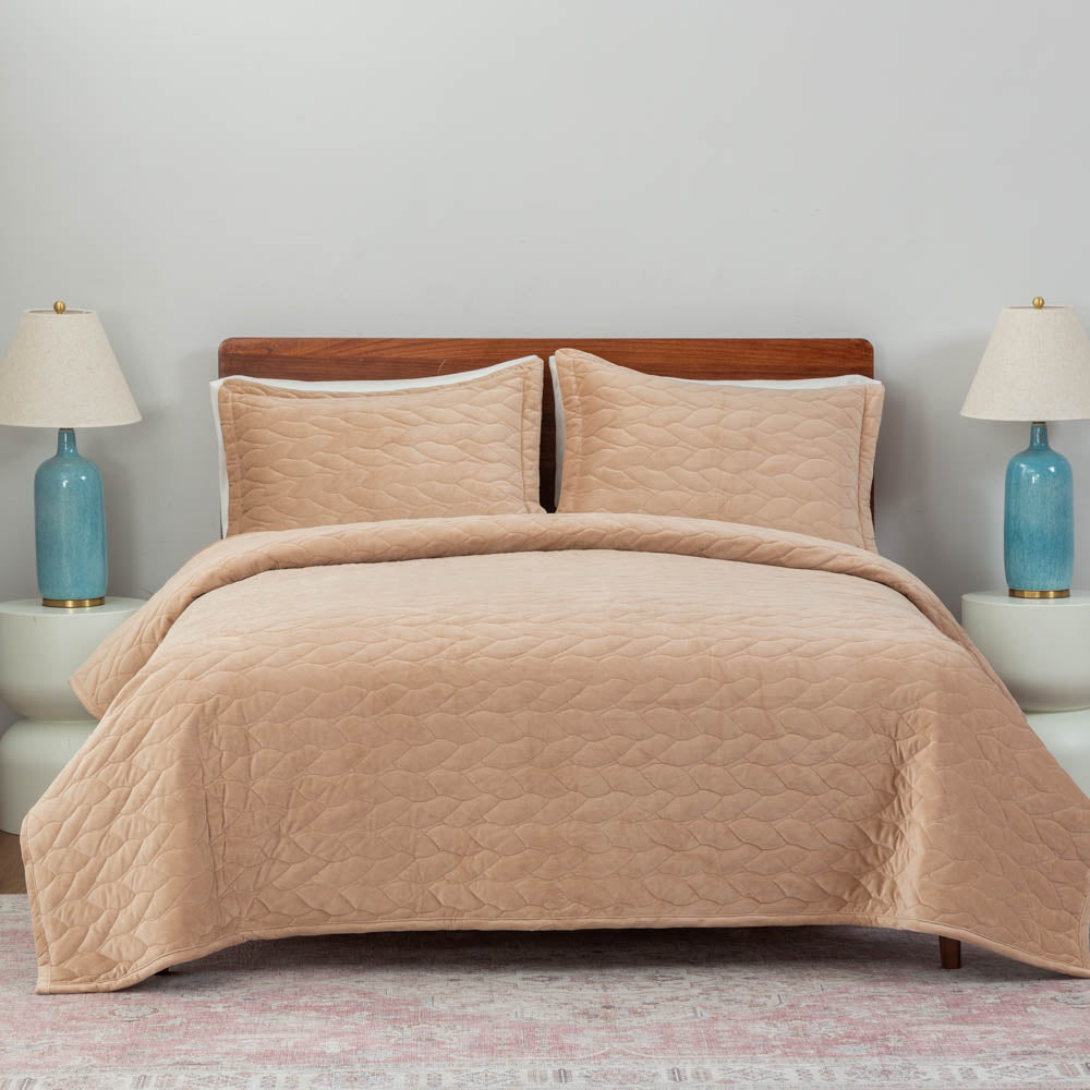 A bed made with the Linen VelvetLoft® Quilt Set, showcasing a clean and crisp bedding arrangement.