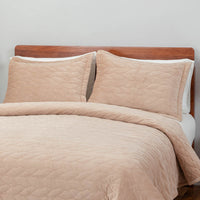 A bed made with the Linen VelvetLoft® Quilt Set, showcasing a clean and crisp bedding arrangement.