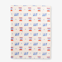 Printed Peanuts 75th Anniversary Throw laid flat on a white surface.