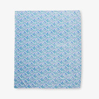 Krissy Mast Artist Series printed cherry blossom print throw laid flat on a white surface.