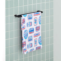 Close up of a Krissy Mast Sardine draped neatly over a metal towel holder in a bathroom.