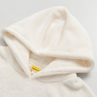 Close up of the hood on our Peanuts social club embroidered lounge hoodie hung laying on a white surface.
