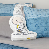 Pillow with cartoon character on a bed with blue and gray bedding