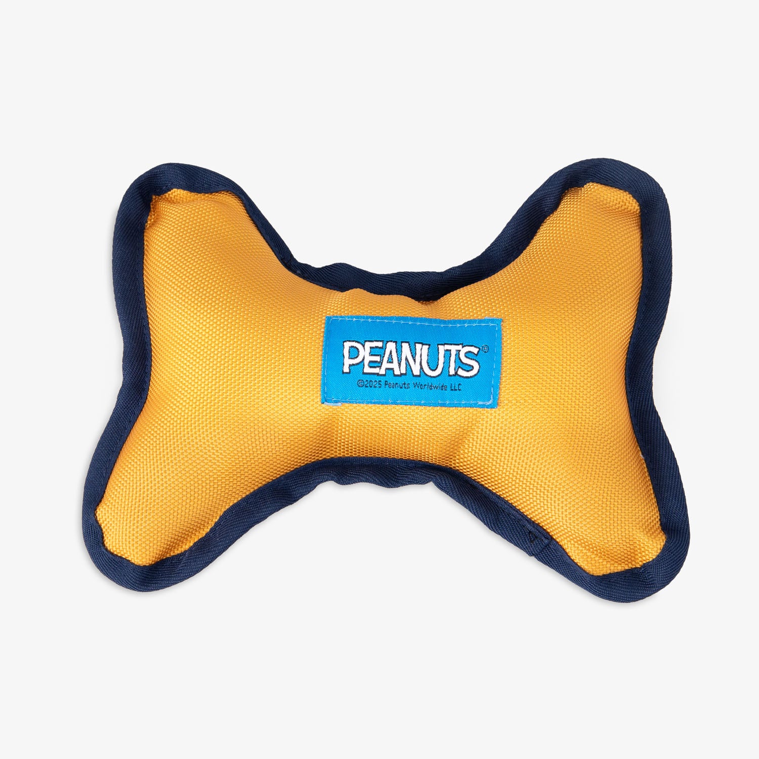 Peanuts dog toy sitting on a white surface.