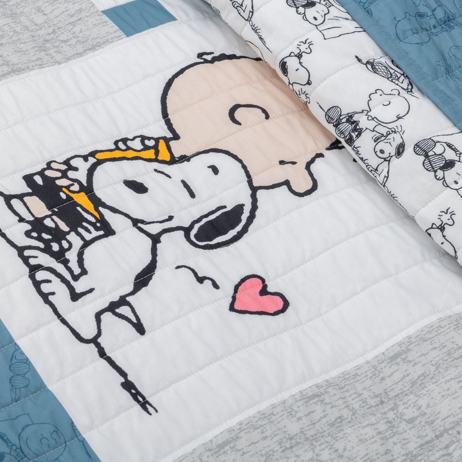 Close up of a Peanuts patchwork quilt set.