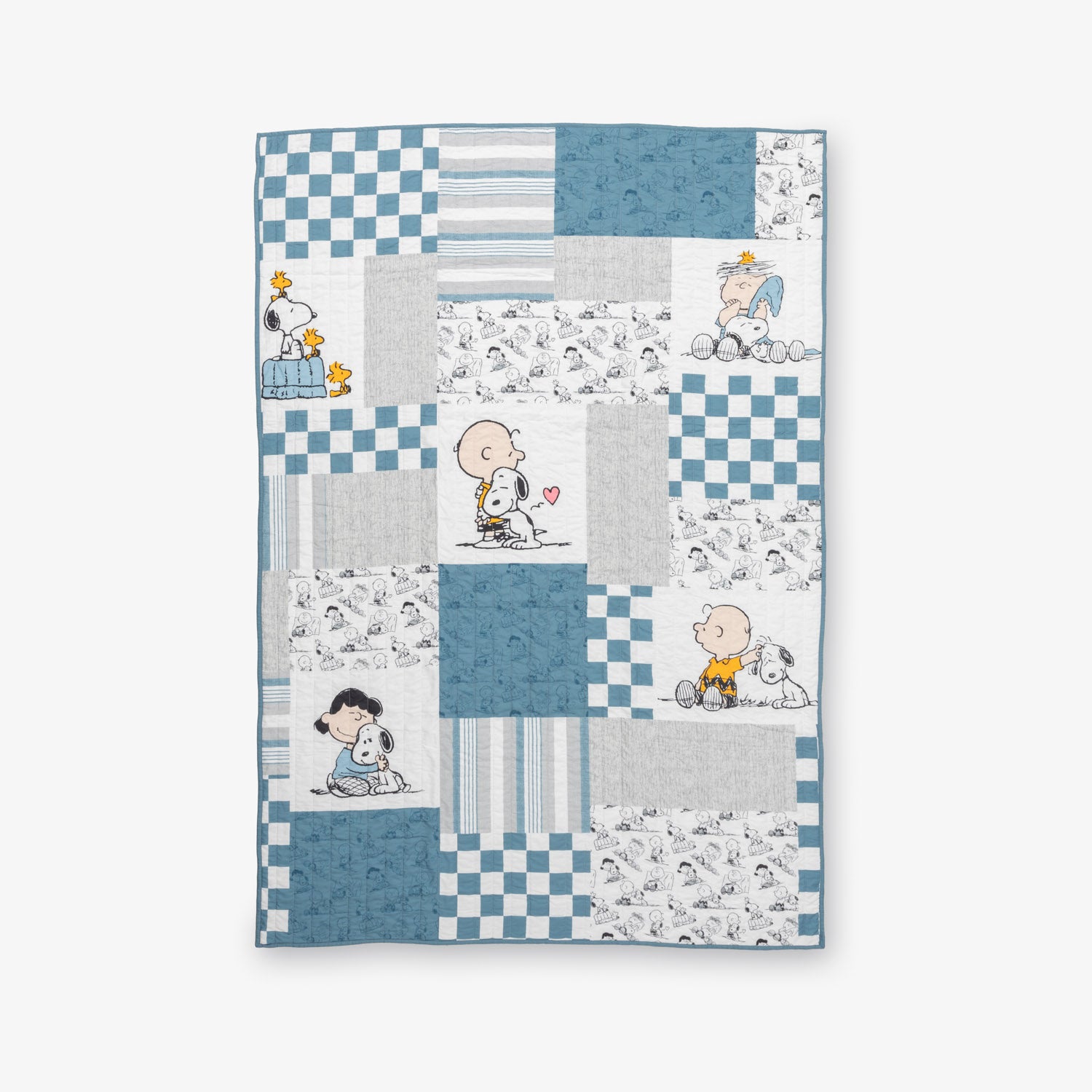 Peanuts patchwork quilt set laid flat on a white surface.