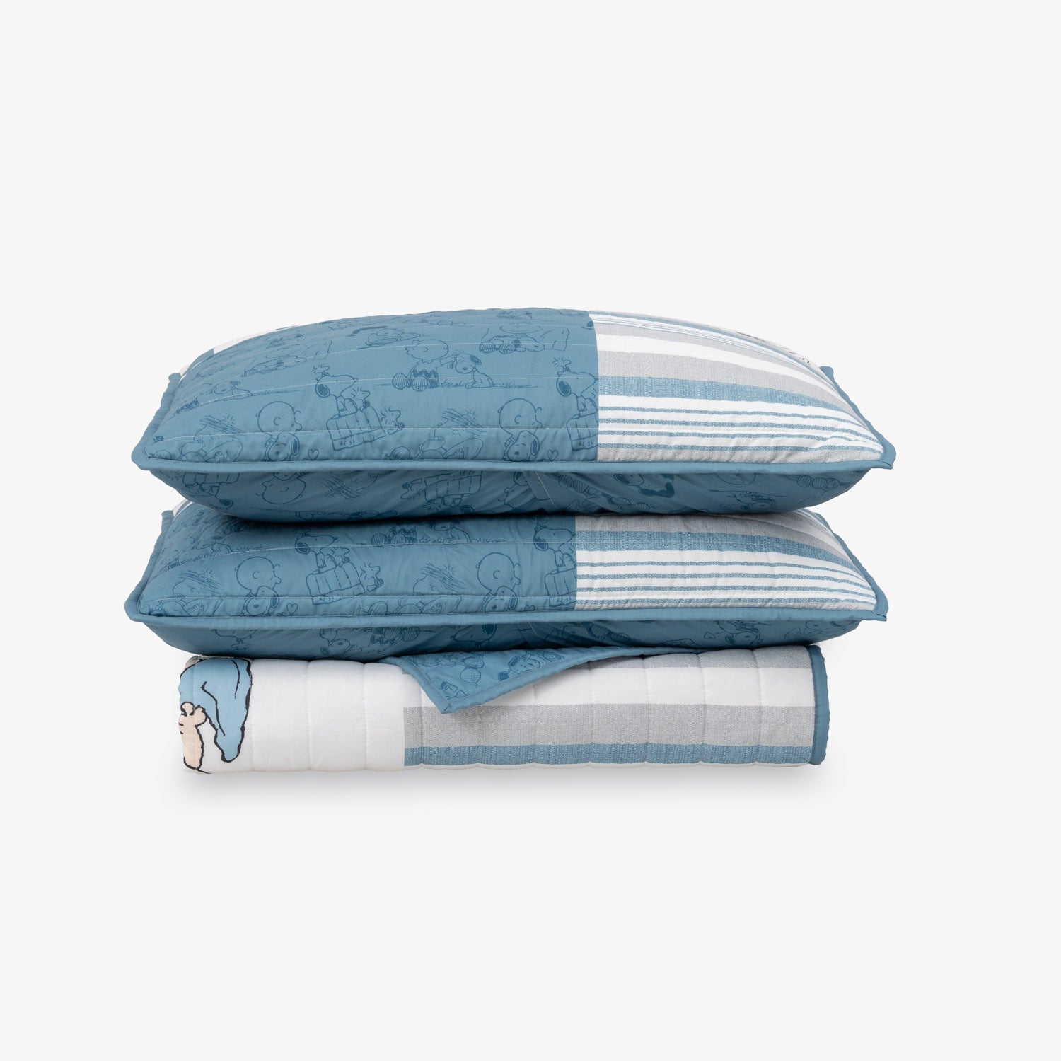Peanuts patchwork quilt set folded neatly on a white surface.