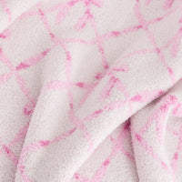 Close up of a Krissy Mast Mellowsoft Bow Throw.