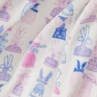 Close up of a cocktail and bows printed velvetloft throw.