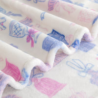 Close up of a cocktail and bows printed velvetloft throw.