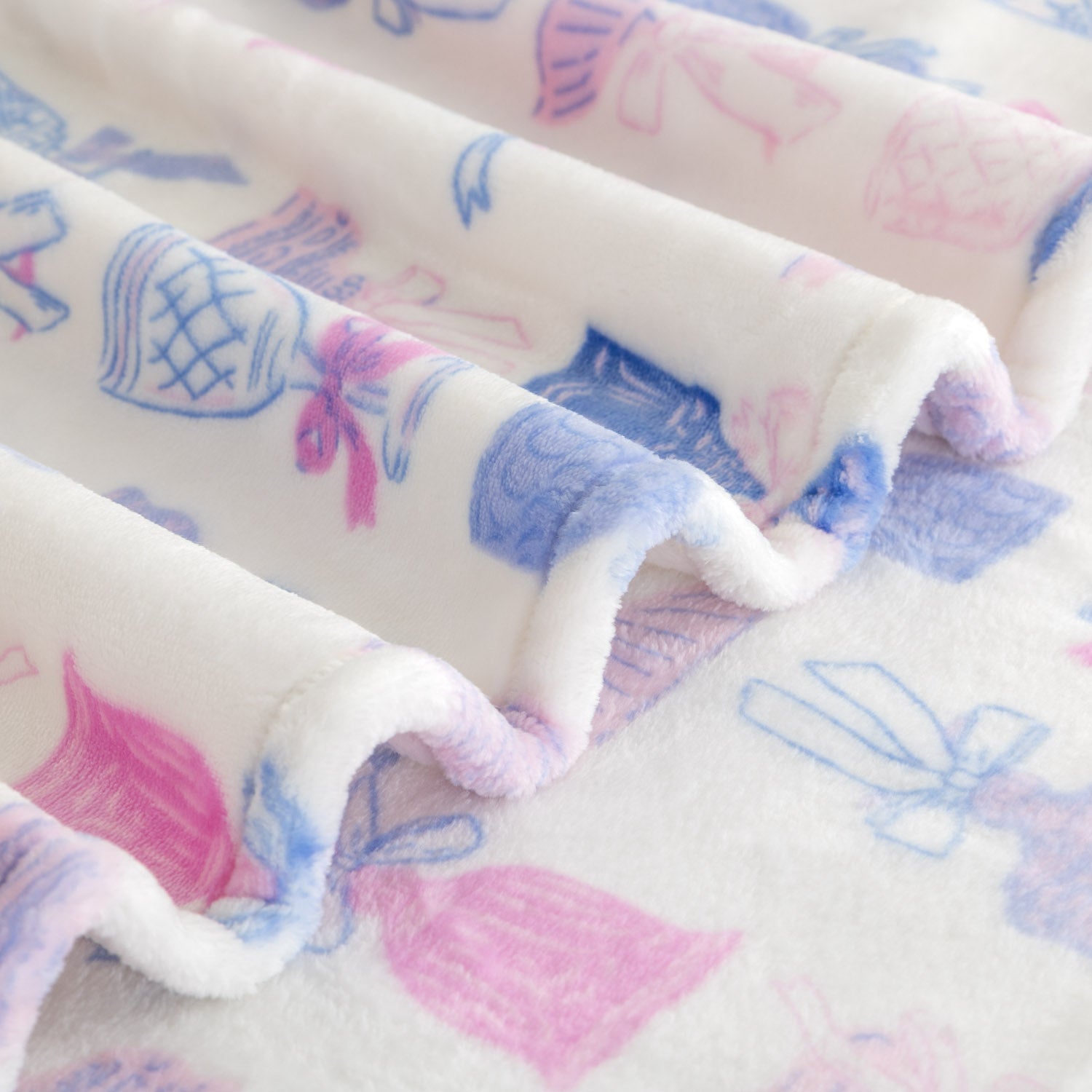 Close up of a cocktail and bows printed velvetloft throw.