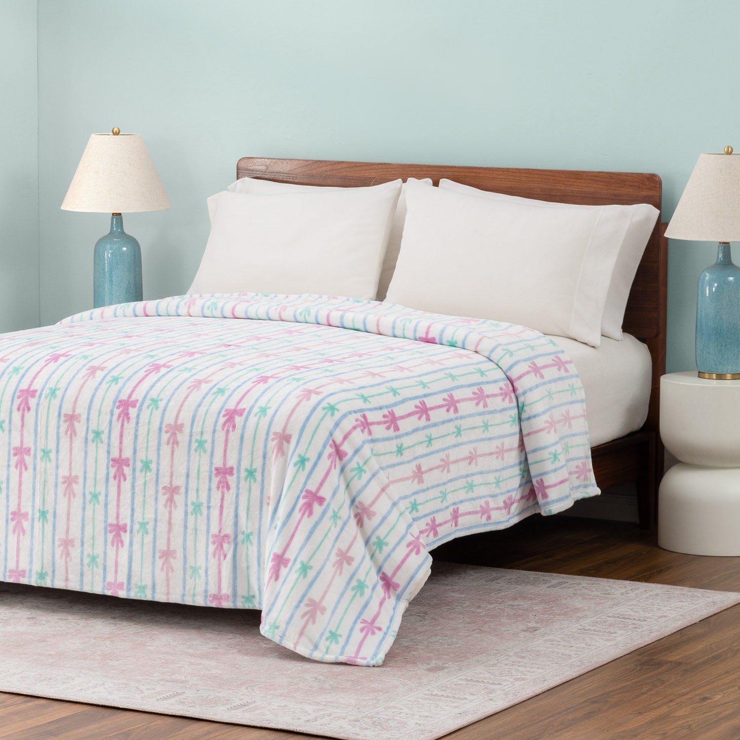 Bed with a colorful striped blanket in a bedroom setting