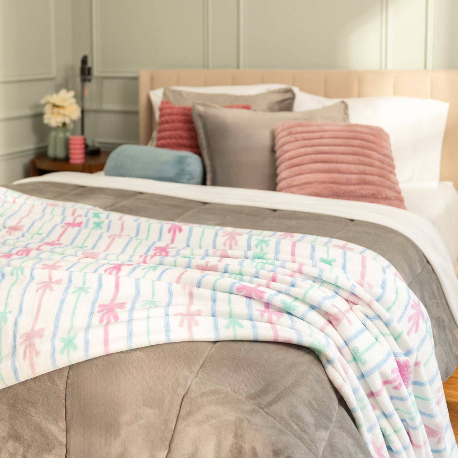 Bed with colorful blanket and pillows in a bedroom setting