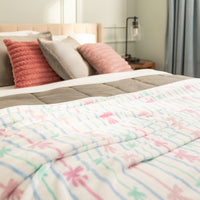 Bed with colorful comforter and pillows in a bedroom setting
