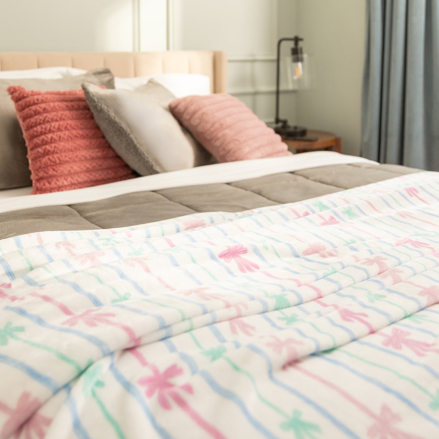 Bed with colorful comforter and pillows in a bedroom setting