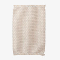 Woven rectangular throw with a subtle pattern on a white background