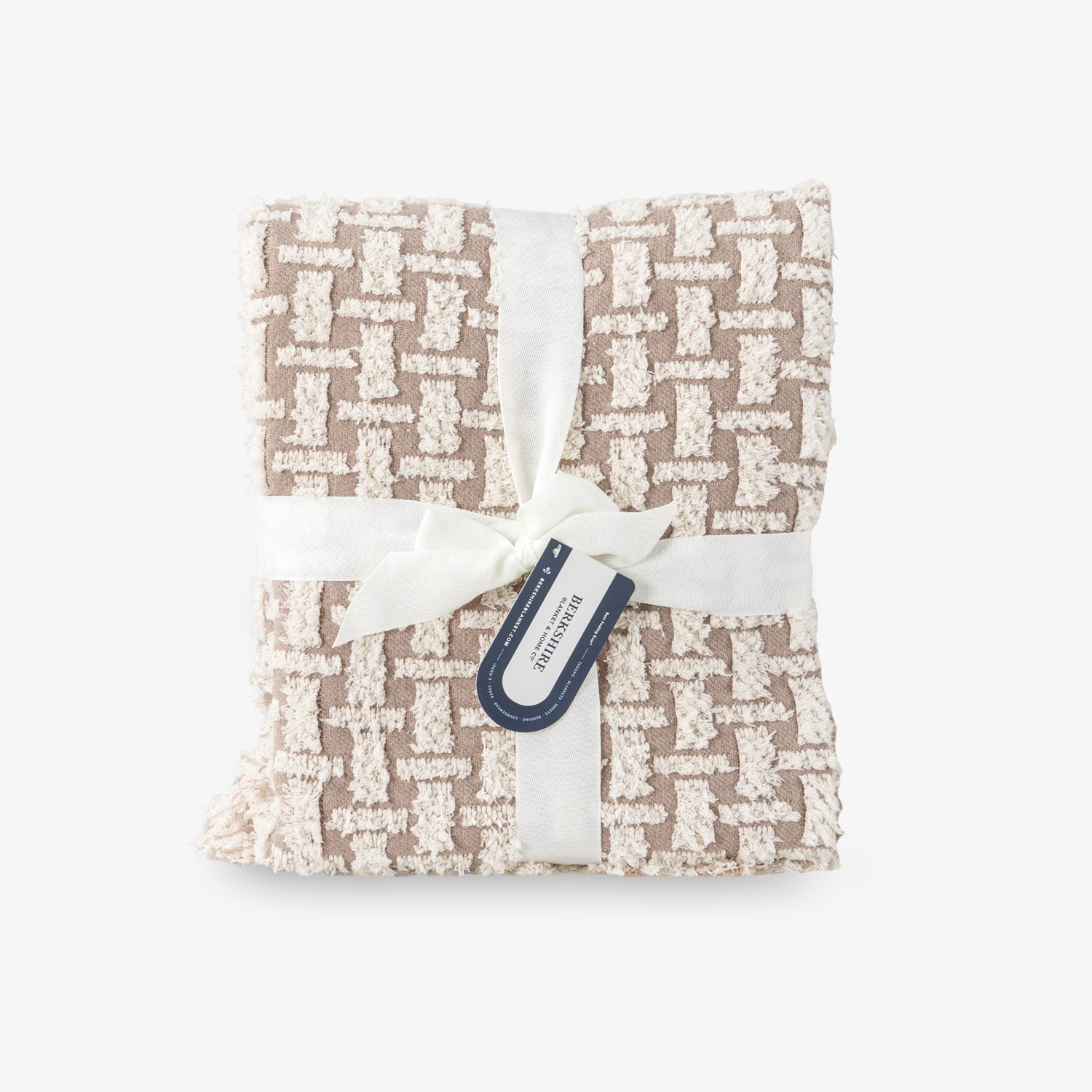 Folded fabric with a geometric pattern and a visible tag on a white background
