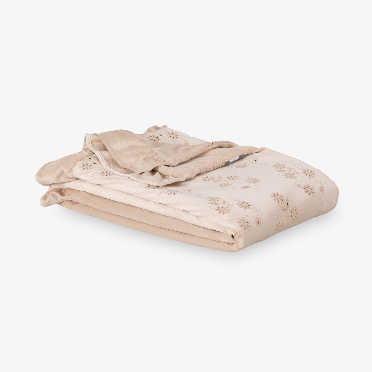 Eyelet ruffle throw folded neatly on a white surface.