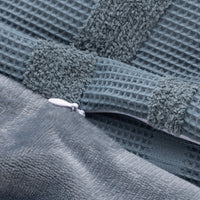 Close-up of a textured gray fabric with a zipper